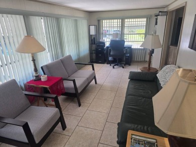 TWO DRIVEWAYS PROVIDE ADDITIONAL PARKING - NICE CORNER LOT - on Grasslands Golf and Country Club in Florida - for sale on GolfHomes.com, golf home, golf lot