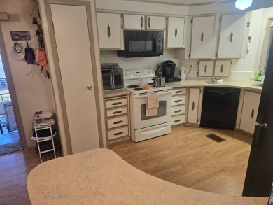 TWO DRIVEWAYS PROVIDE ADDITIONAL PARKING - NICE CORNER LOT - on Grasslands Golf and Country Club in Florida - for sale on GolfHomes.com, golf home, golf lot
