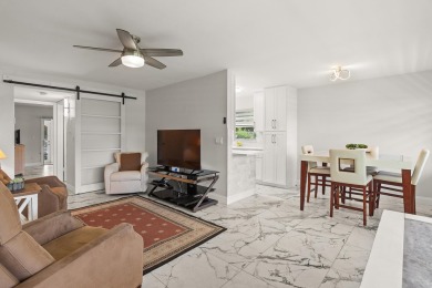 Charming, light-filled 1BR/1.5BA first-floor end unit nestled in on The American Golf Club in Florida - for sale on GolfHomes.com, golf home, golf lot
