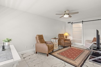 Charming, light-filled 1BR/1.5BA first-floor end unit nestled in on The American Golf Club in Florida - for sale on GolfHomes.com, golf home, golf lot