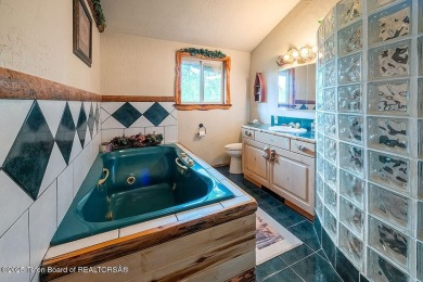 Experience the charm of rustic elegance at 590 Walnut Drive on Star Valley RV Golf Course in Wyoming - for sale on GolfHomes.com, golf home, golf lot