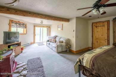 Experience the charm of rustic elegance at 590 Walnut Drive on Star Valley RV Golf Course in Wyoming - for sale on GolfHomes.com, golf home, golf lot