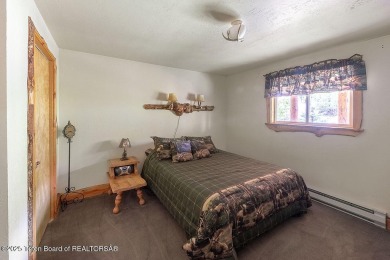Experience the charm of rustic elegance at 590 Walnut Drive on Star Valley RV Golf Course in Wyoming - for sale on GolfHomes.com, golf home, golf lot