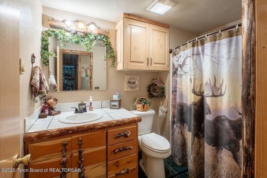 Experience the charm of rustic elegance at 590 Walnut Drive on Star Valley RV Golf Course in Wyoming - for sale on GolfHomes.com, golf home, golf lot