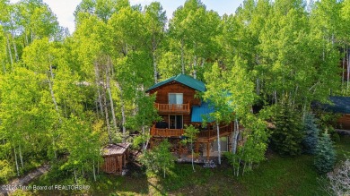 Experience the charm of rustic elegance at 590 Walnut Drive on Star Valley RV Golf Course in Wyoming - for sale on GolfHomes.com, golf home, golf lot