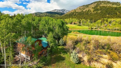 Experience the charm of rustic elegance at 590 Walnut Drive on Star Valley RV Golf Course in Wyoming - for sale on GolfHomes.com, golf home, golf lot