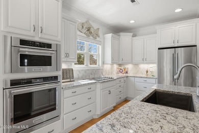 This all-brick home built in 2017 enjoys expansive pond views on Members Club At St. James Plantation in North Carolina - for sale on GolfHomes.com, golf home, golf lot