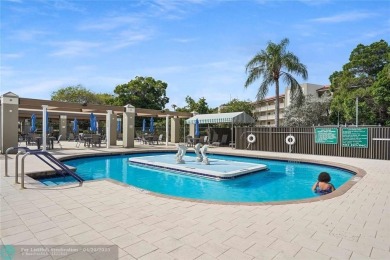 BACK ON THE MARKET WITH NEW KITCHEN WATERFALL COUNTERTOP AND on Wynmoor Golf Course in Florida - for sale on GolfHomes.com, golf home, golf lot