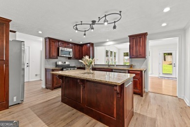 Discover this beautifully maintained brick 4-bedroom, 2.5-bath on Canongate At Flat Creek Club in Georgia - for sale on GolfHomes.com, golf home, golf lot