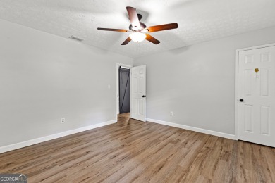 Discover this beautifully maintained brick 4-bedroom, 2.5-bath on Canongate At Flat Creek Club in Georgia - for sale on GolfHomes.com, golf home, golf lot