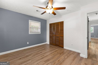 Discover this beautifully maintained brick 4-bedroom, 2.5-bath on Canongate At Flat Creek Club in Georgia - for sale on GolfHomes.com, golf home, golf lot