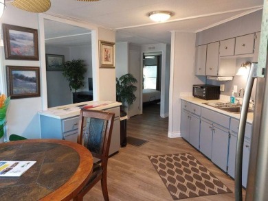 The Lot Rent for this home is $1,047.00/monthly. A cozy on Lake Fairways Country Club in Florida - for sale on GolfHomes.com, golf home, golf lot