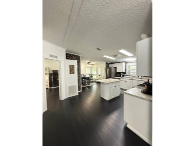 Prepare to be captivated by this **completely reimagined gem** on Hamptons Golf Club in Florida - for sale on GolfHomes.com, golf home, golf lot
