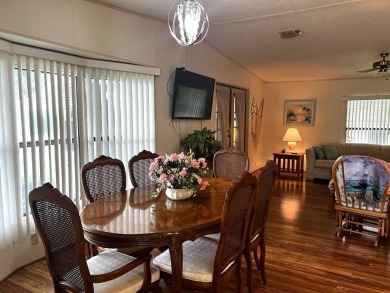 This delightful 2-bedroom, 2-bathroom retreat boasts a generous on Lake Henry Golf Club in Florida - for sale on GolfHomes.com, golf home, golf lot