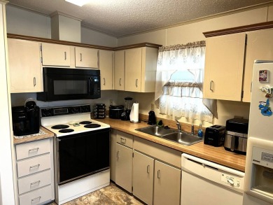 This delightful 2-bedroom, 2-bathroom retreat boasts a generous on Lake Henry Golf Club in Florida - for sale on GolfHomes.com, golf home, golf lot