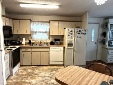 This delightful 2-bedroom, 2-bathroom retreat boasts a generous on Lake Henry Golf Club in Florida - for sale on GolfHomes.com, golf home, golf lot