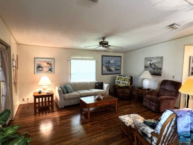 This delightful 2-bedroom, 2-bathroom retreat boasts a generous on Lake Henry Golf Club in Florida - for sale on GolfHomes.com, golf home, golf lot
