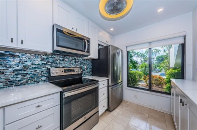 Find paradise in this one-of-a-kind lakefront villa in beautiful on Isla Del Sol Yacht and Country Club in Florida - for sale on GolfHomes.com, golf home, golf lot