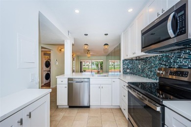 Find paradise in this one-of-a-kind lakefront villa in beautiful on Isla Del Sol Yacht and Country Club in Florida - for sale on GolfHomes.com, golf home, golf lot