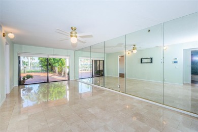 Find paradise in this one-of-a-kind lakefront villa in beautiful on Isla Del Sol Yacht and Country Club in Florida - for sale on GolfHomes.com, golf home, golf lot
