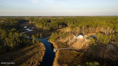 Nestled at the end of the cul de sac, this creek cottage will on Minnesott Golf and Country Club in North Carolina - for sale on GolfHomes.com, golf home, golf lot