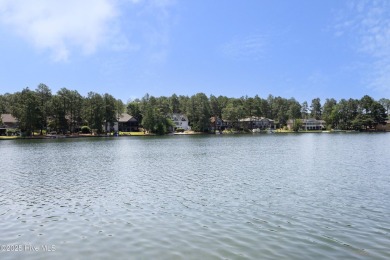 This exceptional lakefront home, located in Seven Lakes West on Beacon Ridge Golf and Country Club in North Carolina - for sale on GolfHomes.com, golf home, golf lot
