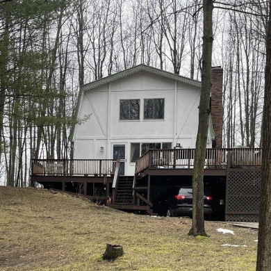 Check out this home with lake access!  Enjoy the beauty and all on Canadian Lakes Country Club-The Highlands Course in Michigan - for sale on GolfHomes.com, golf home, golf lot