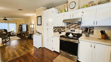 Nestled within the highly sought-after golf course community of on Blue Heron Pines Golf Course in Florida - for sale on GolfHomes.com, golf home, golf lot