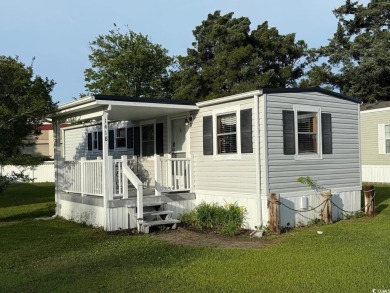 This cozy 2 bed, 1 bath furnished mobile home in the Waterway on Barefoot Resort and Golf Club  in South Carolina - for sale on GolfHomes.com, golf home, golf lot