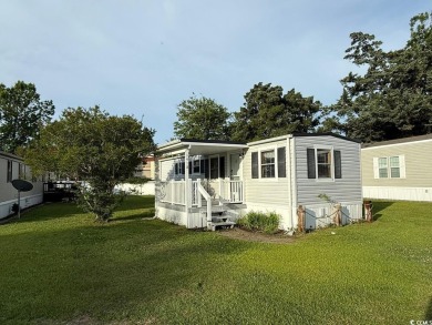 This cozy 2 bed, 1 bath furnished mobile home in the Waterway on Barefoot Resort and Golf Club  in South Carolina - for sale on GolfHomes.com, golf home, golf lot