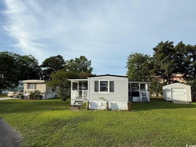 This cozy 2 bed, 1 bath furnished mobile home in the Waterway on Barefoot Resort and Golf Club  in South Carolina - for sale on GolfHomes.com, golf home, golf lot