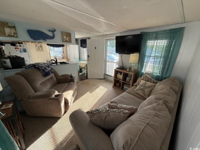 This cozy 2 bed, 1 bath furnished mobile home in the Waterway on Barefoot Resort and Golf Club  in South Carolina - for sale on GolfHomes.com, golf home, golf lot