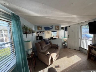 This cozy 2 bed, 1 bath furnished mobile home in the Waterway on Barefoot Resort and Golf Club  in South Carolina - for sale on GolfHomes.com, golf home, golf lot