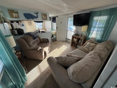 This cozy 2 bed, 1 bath furnished mobile home in the Waterway on Barefoot Resort and Golf Club  in South Carolina - for sale on GolfHomes.com, golf home, golf lot