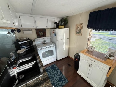 This cozy 2 bed, 1 bath furnished mobile home in the Waterway on Barefoot Resort and Golf Club  in South Carolina - for sale on GolfHomes.com, golf home, golf lot