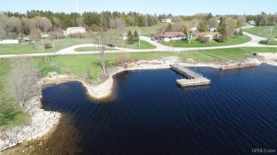 Escape to your own waterfront paradise on Garden Bay! This on Garden Golf Course in Michigan - for sale on GolfHomes.com, golf home, golf lot