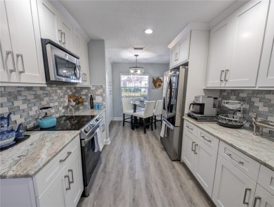 Enjoy this Beautiful two-story pool home, in the private and on The Grand Club - Pine Lakes Course in Florida - for sale on GolfHomes.com, golf home, golf lot