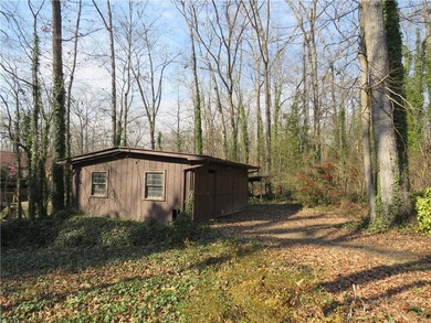This 4 bedroom, 3 bath ranch has perfect bones and a great floor on Cherokee Golf and Country Club in Georgia - for sale on GolfHomes.com, golf home, golf lot