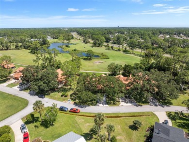 This exceptional end-unit townhome is strategically located on on The Grand Club - Pine Lakes Course in Florida - for sale on GolfHomes.com, golf home, golf lot