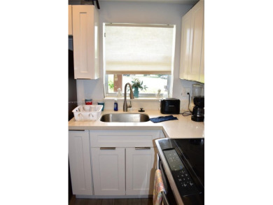 Nice, first floor 1 bedroom apartment with renovated kitchen on Sunrise Lakes Phase III in Florida - for sale on GolfHomes.com, golf home, golf lot