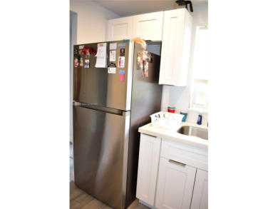 Nice, first floor 1 bedroom apartment with renovated kitchen on Sunrise Lakes Phase III in Florida - for sale on GolfHomes.com, golf home, golf lot