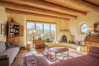 Charming Adobe Pumice Home with Expansive Mountain Views on Taos Country Club in New Mexico - for sale on GolfHomes.com, golf home, golf lot