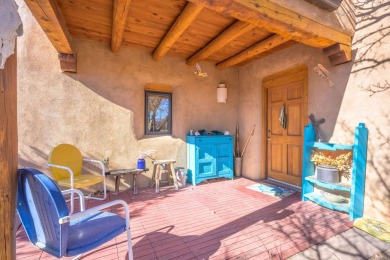 Charming Adobe Pumice Home with Expansive Mountain Views on Taos Country Club in New Mexico - for sale on GolfHomes.com, golf home, golf lot