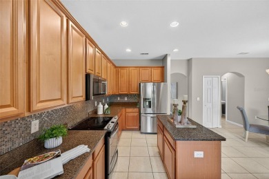 SCENIC. SPACIOUS. SERENEe visit this 4-bedroom, 2.5-bath home on on Meadow Oaks Golf and Country Club in Florida - for sale on GolfHomes.com, golf home, golf lot