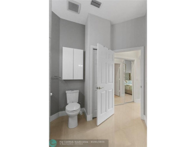 Very rarely available corner villa overlooking a canal and the on Palm-Aire Country Club and Resort - The Oaks in Florida - for sale on GolfHomes.com, golf home, golf lot