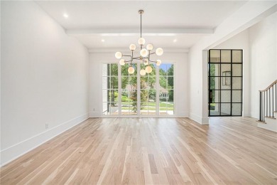 Set on a sprawling 1-acre lot in an established, tree-lined on Dunwoody Country Club in Georgia - for sale on GolfHomes.com, golf home, golf lot