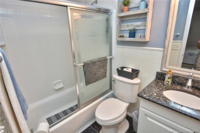 Updated dark floors add drama to the decor in this one bedroom 1 on Pine Lakes Golf Club in Florida - for sale on GolfHomes.com, golf home, golf lot