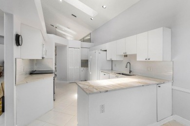 From the moment you walk in, you're greeted with volume ceilings on Indian Spring Golf and Country Club in Florida - for sale on GolfHomes.com, golf home, golf lot