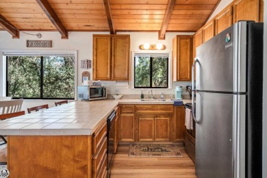 Relax and stay in this charming 3-bedroom, 2-bath cabin nestled on Pine Mountain Lake Country Club in California - for sale on GolfHomes.com, golf home, golf lot