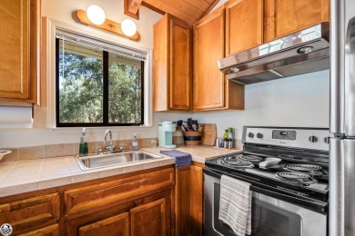 Relax and stay in this charming 3-bedroom, 2-bath cabin nestled on Pine Mountain Lake Country Club in California - for sale on GolfHomes.com, golf home, golf lot